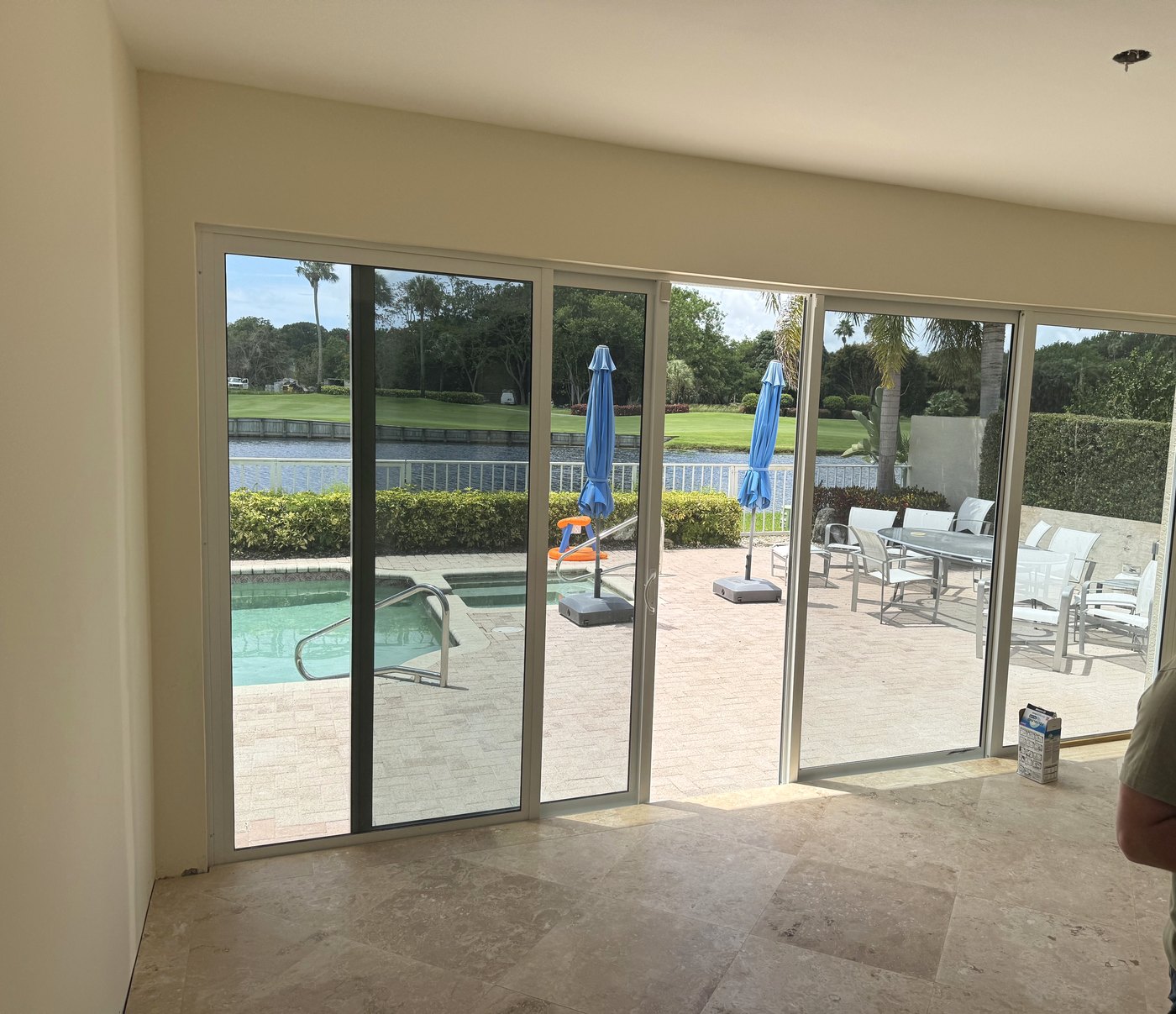 Finished glass-walled living room after patio enclosure